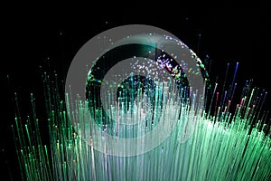 Abstract background with colored fibers optics reflected on glass sphere