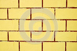 Abstract wallpaper texture stone yellow brick. Pattern on wall for abstract background. The yellow wall is divided into several
