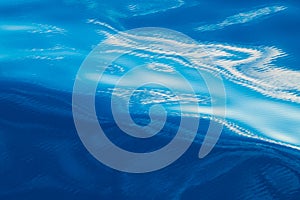 Abstract water background. Calm ocean water surface with curled white reflections