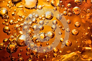 Abstract water with  bubbles soars over a golden background