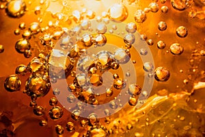 Abstract water with  bubbles soars over a golden background