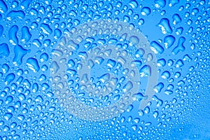 The Abstract water drop on surface of fresh blue background