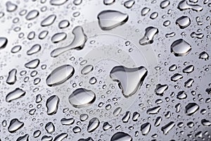 Abstract water drops on polished stainless steel surface