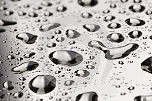 Abstract water drops on polished stainless steel surface