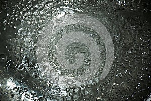 abstract water splash with graphic motion flow bubbles above dark background, art screen, and natural environment concept