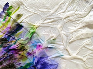 Abstract watercolor hand painted background. Multicolor stain of paint on a white napkin