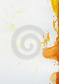 Abstract watercolor painted background with orange and yellow paint spots on textured paper