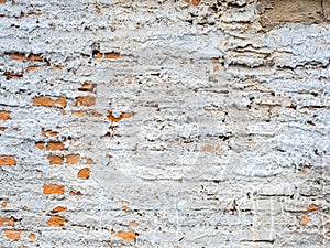 Abstract white grunge peeling cement texture on brick wall background. Old crack plaster concrete wall.