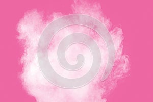 Abstract white powder explosion on pink background. Freeze motion of white dust splattered