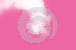 Abstract white powder explosion on pink background. Freeze motion of white dust splattered