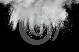 Abstract white powder explosion.White dust debris on black background