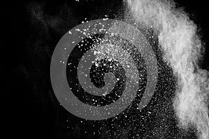 Abstract white powder explosion.White dust debris on black background