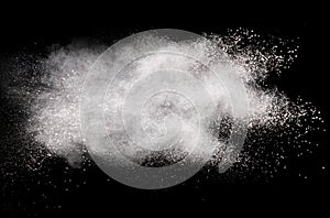 Abstract white powder splatted on black background,Freeze motion