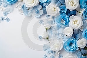 Abstract white roses and blue flowers bordering white background photo