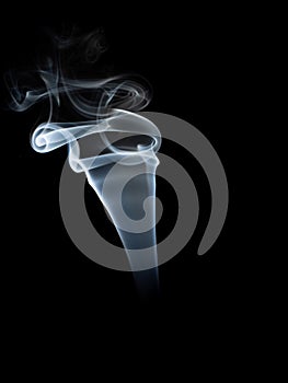 Abstract white smoke swirls on black background.