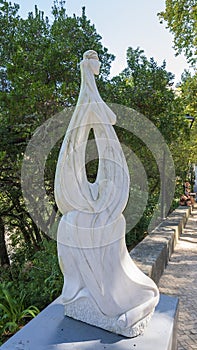 Abstract white stone sculpture of naked woman along the Volta do Duche in Sintra, Portugal.