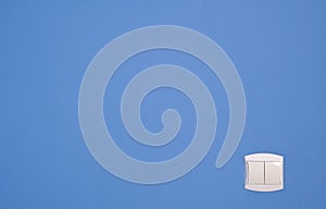 Abstract wide angle light switch on blue wall