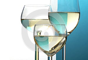 Abstract wine glasses, background half blue, half white, copy sp