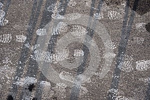 Abstract winter weather background. Winter concept. Winter walk. Salt footprints on asphalt.