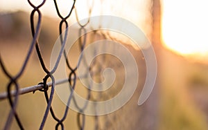 Abstract wired fence in the sunset