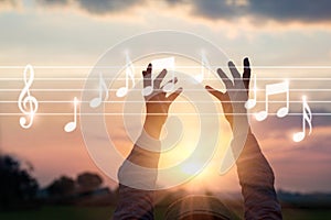 Abstract woman hands touching music notes on nature background,