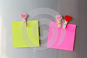 Abstract of wooden heart clip with Blank paper and stick paper on refrigerator door. paper note copy space for add text. valentine