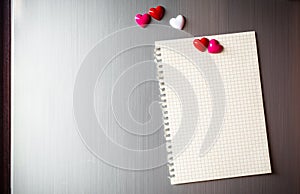 Abstract of wooden heart clip with Blank paper and stick paper on refrigerator door. paper note copy space for add text. valentine