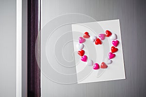 Abstract of wooden heart clip with Blank paper and stick paper on refrigerator door. paper note copy space for add text. valentine
