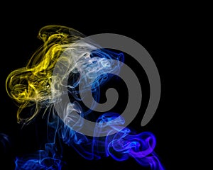 Abstract yellow-blue smoke from aromatic sticks.
