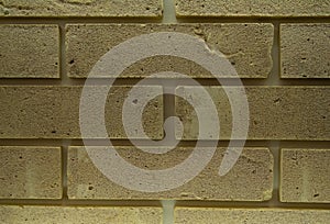 Abstract yellow brick wall pattern with artificially aged surface for graphic design, texture, surface print