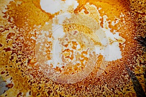 Abstract yellow-orange burning cream texture in white background. Milk burning pots orange-yellow texture. Abstract rustic texture