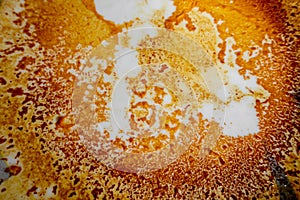 Abstract yellow-orange burning cream texture in white background. Milk burning pots orange-yellow texture. Abstract rustic texture