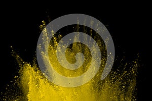 Abstract of yellow powder explosion on black background. Yellow