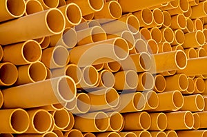 Abstract yellow PVC pipes stacked horizontally and vertically at an exhibition