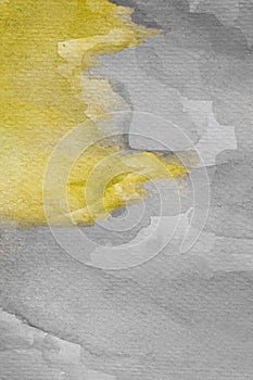 Abstract yellow watercolor on textured paper. Yellow and gray hand painted watercolor background.