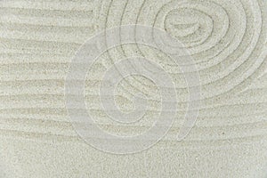 Abstract Zen drawing on white sand. Concept of harmony, balance and meditation, spa, massage, relax.