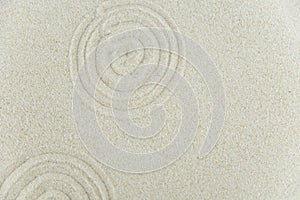 Abstract Zen drawing on white sand. Concept of harmony, balance and meditation, spa, massage, relax.