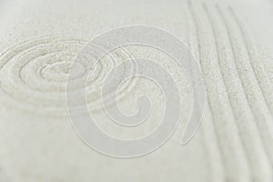 Abstract Zen drawing on white sand. Concept of harmony, balance and meditation, spa, massage, relax.