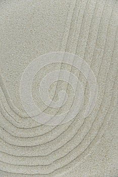Abstract Zen drawing on white sand. Concept of harmony, balance and meditation, spa, massage, relax.