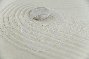 Abstract Zen drawing on white sand. Concept of harmony, balance and meditation, spa, massage, relax.