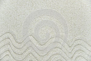 Abstract Zen drawing on white sand. Concept of harmony, balance and meditation, spa, massage, relax.