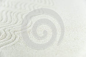 Abstract Zen drawing on white sand. Concept of harmony, balance and meditation, spa, massage, relax.