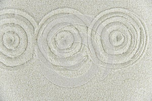 Abstract Zen drawing on white sand. Concept of harmony, balance and meditation, spa, massage, relax.