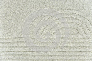 Abstract Zen drawing on white sand. Concept of harmony, balance and meditation, spa, massage, relax.