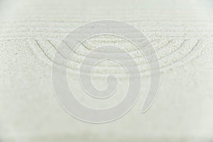 Abstract Zen drawing on white sand. Concept of harmony, balance and meditation, spa, massage, relax.