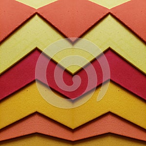 abstract zig zag design with foamy cutouts in red, yellow and orange colors, background and texture