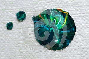 Abstraction. Close-up of a green and blue gemstone on a white background