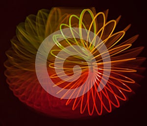 Abstraction of a rainbow spiral on a black background