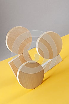 Abstraction from round wooden geometric figures on a gray-yellow background