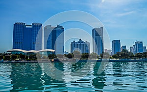 Abu Dhabi city skyline along Corniche beach taken from a boat